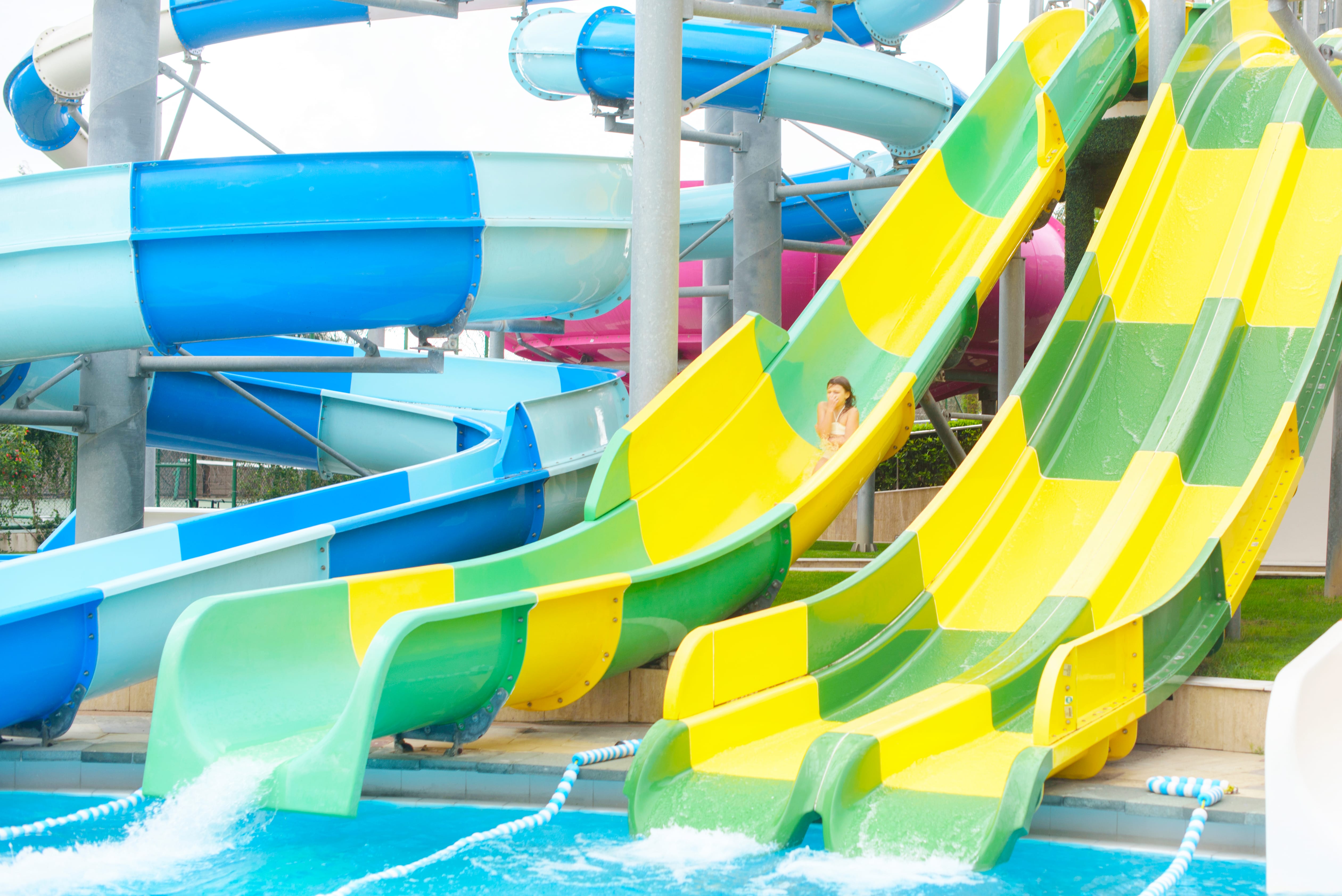Child riding a colorful water park slide
